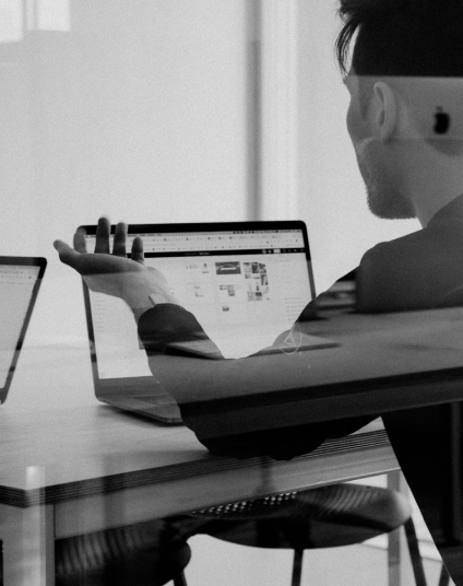 Businessman working on laptop in modern office workspace.